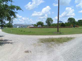 Wide shot of the property from the rear of the house showing the digging on the right