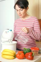 Lady cooking in her kitchen.
