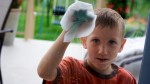 boy washing window