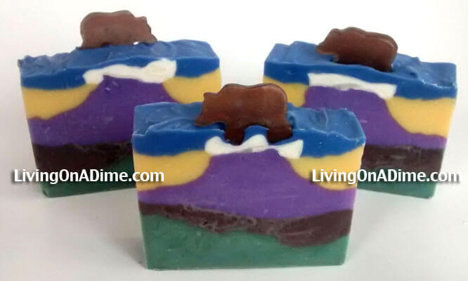This homemade soap is my Rocky Mountain lye soap. It's inspired by the mountain beauty here in Colorado. This is a pretty advanced lye soap to make. You have to wait for each layer to set up before putting the next layer on and then you have to carefully pile the soap in the middle to make the mountain. Then you put a different color on the sides to hold up your mountain. The little bears on top are made of melt and pour soap poured into a bear silicone mold.