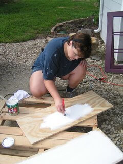 Tawra Painting a Window