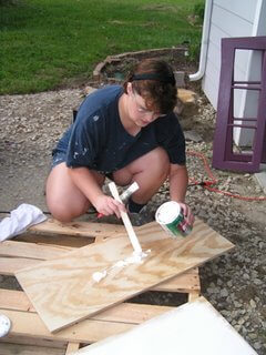 Tawra Painting a Window