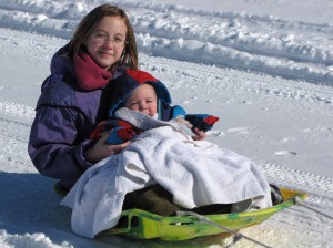 Kids sledding in the snow