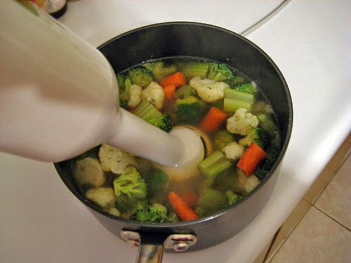 Making homemade vegetable baby food with a hand blender