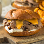 These cheesy French dip sandwiches are a cheap, easy and tasty plan ahead pot roast recipe! You can easily use leftover pot roast or roast beef to make these sandwiches in just a few minutes! They're sure to please your family, save you money and get you out of the kitchen fast!