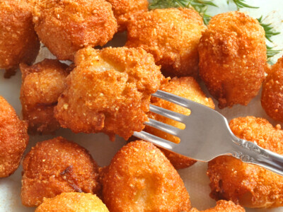 This easy homemade hush puppies recipe makes tasty golden hush puppies just like your favorite restaurant! Crisp and buttery on the outside and delicious and moist and tender on the inside, they are the perfect complement to fried chicken, seafood, barbecue, or just about any comfort meals!