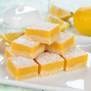 This lemon bars recipe is an easy recipe that everyone, including kids and adults, loves! It's a perfect summer recipe that's crisp, tangy and refreshing like a cool glass of lemonade. Its sunshine yellow color adds a pop of color to the meal and because they're so popular with guests, lemon bars and brownies are usually the first things to disappear at a potluck.