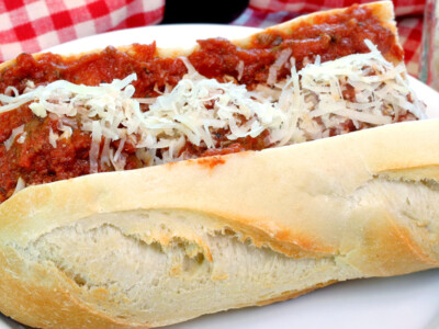 This hearty Italian French Dip sandwiches recipe makes delicious sandwiches loaded with savory Italian sausage, melty cheese, and sautéed onions—grilled to golden perfection and served with a zesty pizza-style tomato dipping sauce. A fun twist on the classic French Dip!